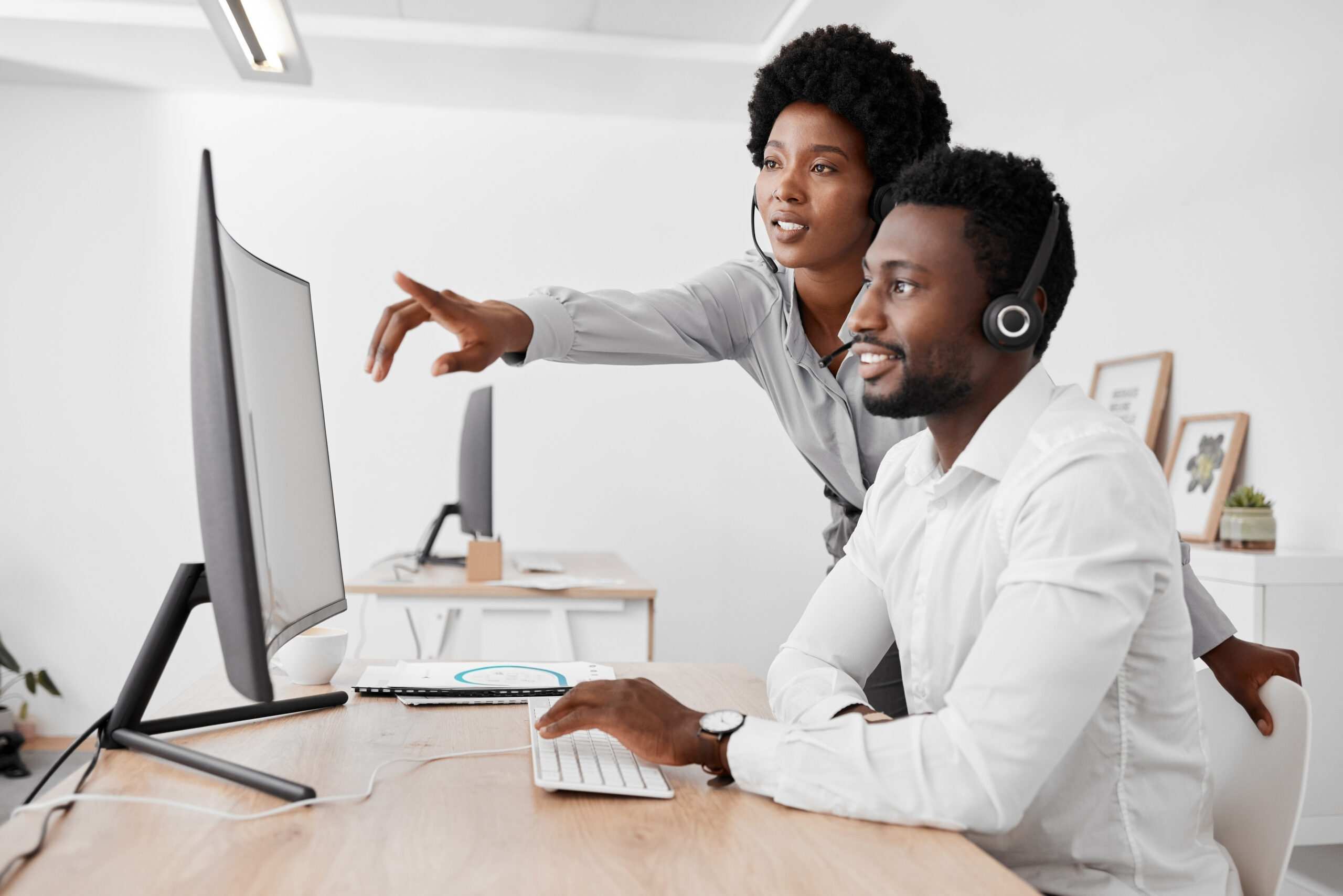 Call center, agency and mentor in customer service and telemarketing business at the office. Black people in consulting, desk and contact us support in teamwork, employee advice and help at work.